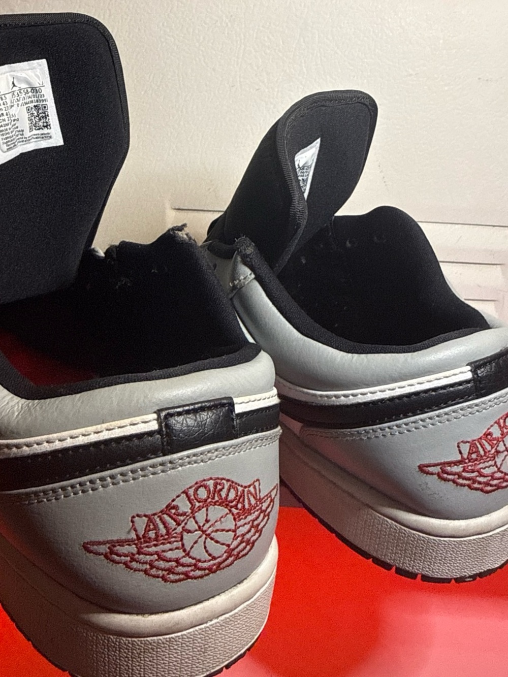 Jordan Low-Top Sneakers in White, Black and Red Wing Logo